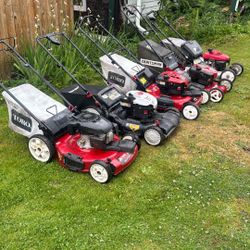 Four self-propelled lawnmowers, and one Honda