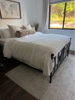 Queen bed frame with queen mattress and box spring.