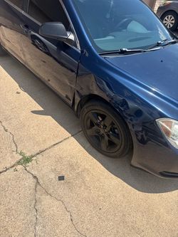 Dark Blue Sedan with Body Damage