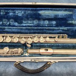 Silver flute in a blue velvet-lined case.