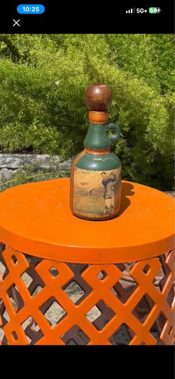 Vintage Decorative Bottle with Golfer Design