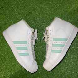 Adidas Pro Model sneakers in a white and teal (or "Collegiate Green" / "Easy Green") colorway. 