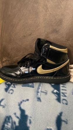 Black and gold Jordan 1s