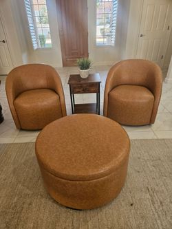 Two round swivel chairs and circular ottoman