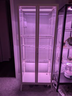 Ikea Milsbo plant cabinet with acrylic shelving lights and self watering pots