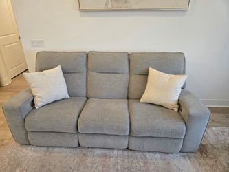 Dual recliners with automatic head rest adjustments