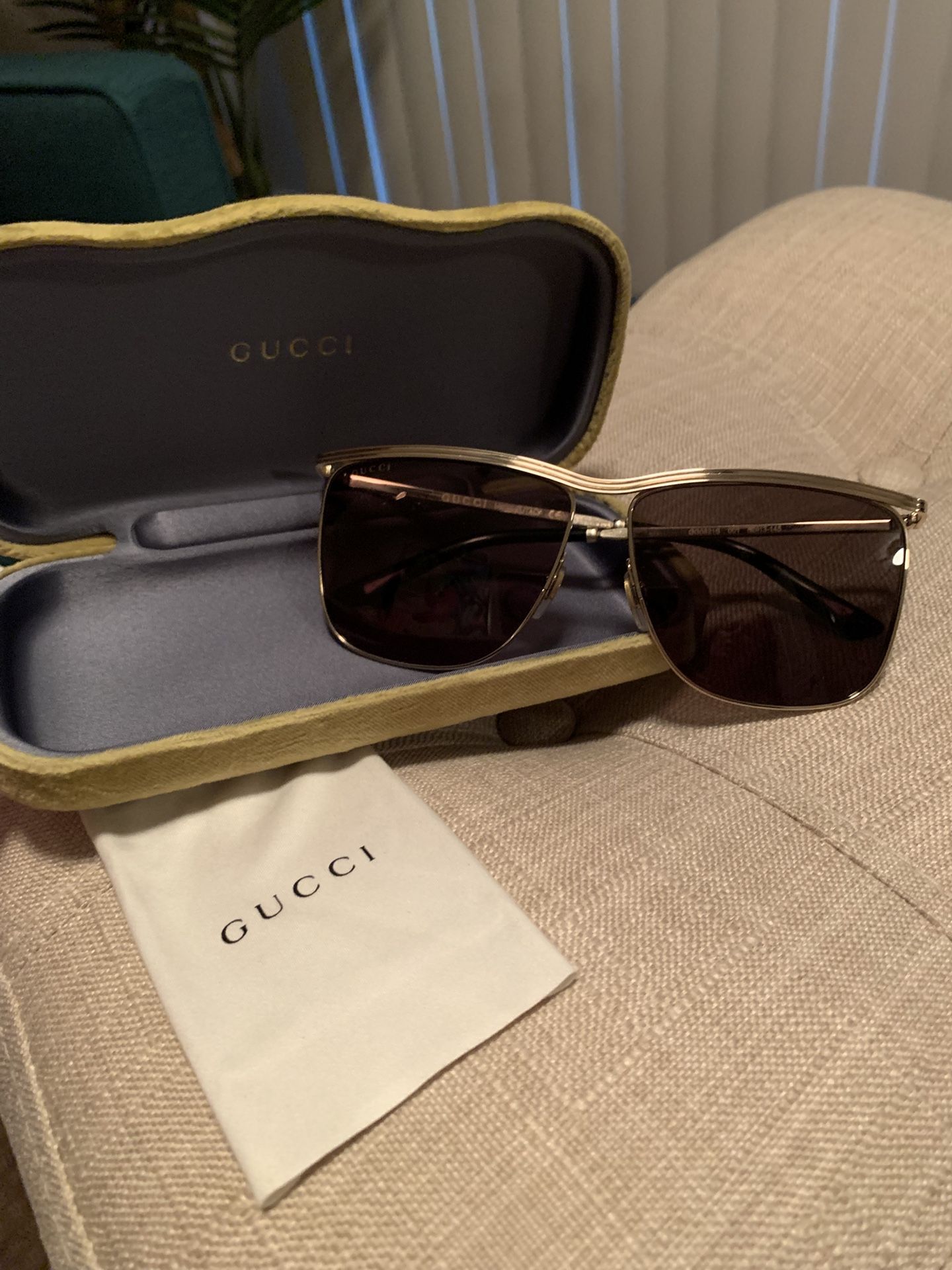 Men’s Gucci aviator sunglasses with gold trim