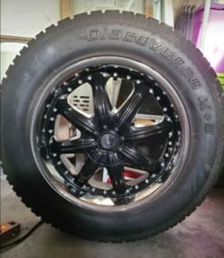Four  Cooper Discoverer A/T Tires on 20" Black Alloy Wheels