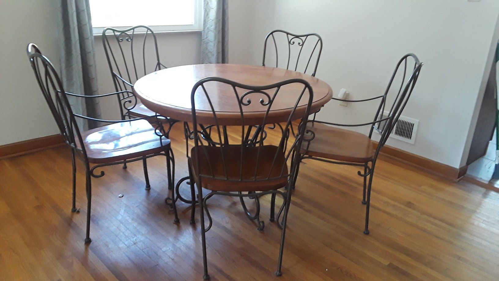 Wood dining kitchen round table with 4 rought iron chairs