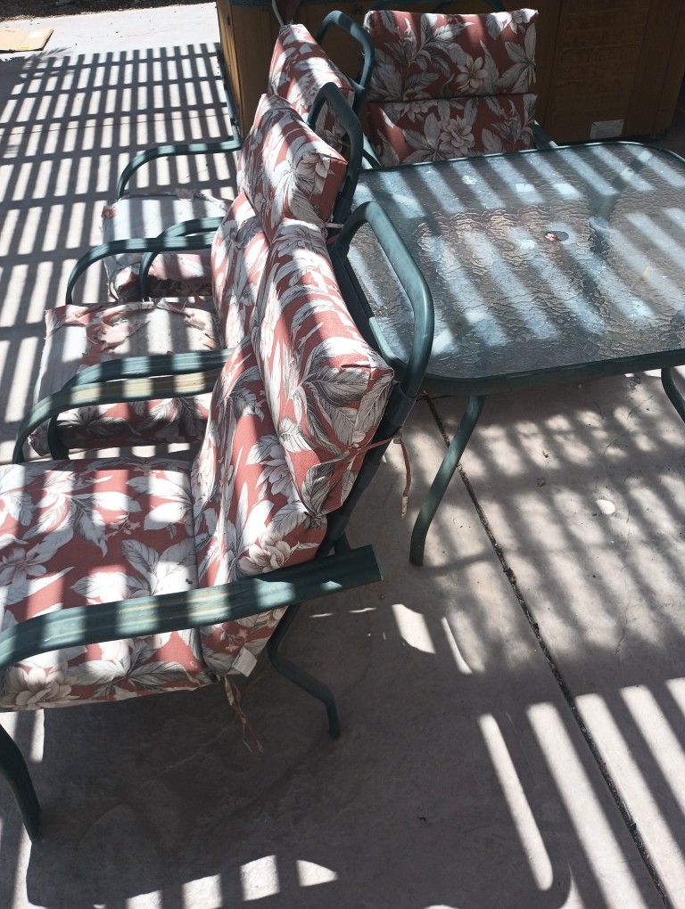 Free Patio Set. 4 Chairs And A Glass Table. Need Painting And New Cushions.