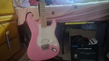 Electric guitar, amp, and headphones