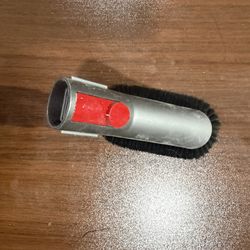 Vacuum Cleaner Brush Attachment with Angled Black Bristles and Red Button