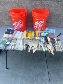 classic orange bucket from The Home Depot, filled with a variety of painting and safety supplies.