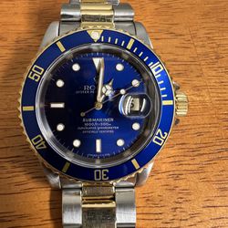 Rolex submariner two tone 42 mm preowned Certified watch  (model year-1993-94 )in 18 Karat yellow gold and stainless original bracelet blue dial , com