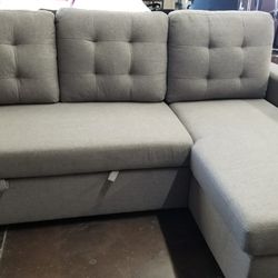 Light gray sofa chaise sectional with a pullout bed