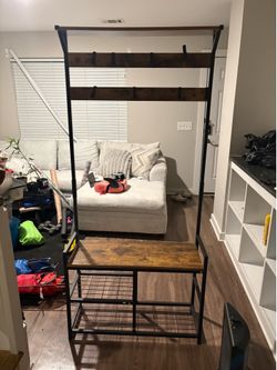 Entryway storage bench with coat hooks