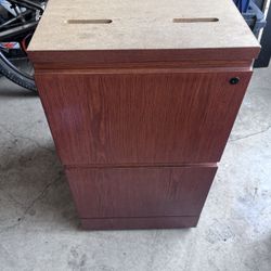 two-drawer wooden file cabinet with a top that is not finished