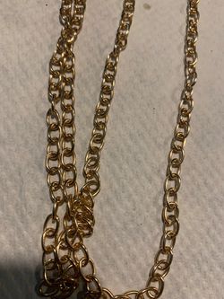 4 ft long gold colored metal necklace with 2 large clasps. Has open link design. New. Can be twisted or wrapped to make it shorter or different looks.