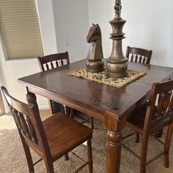 High dining table set with four chairs. 