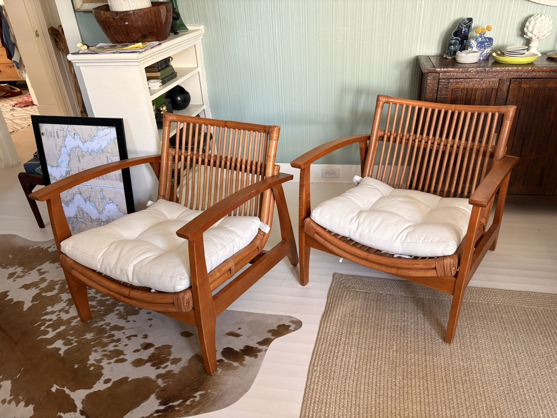 A Pair Of CB2 Noelie curved Rattan And Wood Armchairs