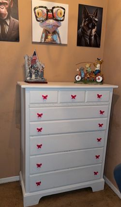 White Dresser with Pink Butterfly Knobs and Matching Pink Book Rack with lots of Books