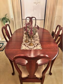 Elegant cherry wood dining table and china cabinet