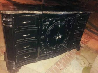 Black dresser with marble on top