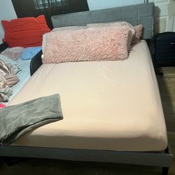 Queen bed with mattress and frame.