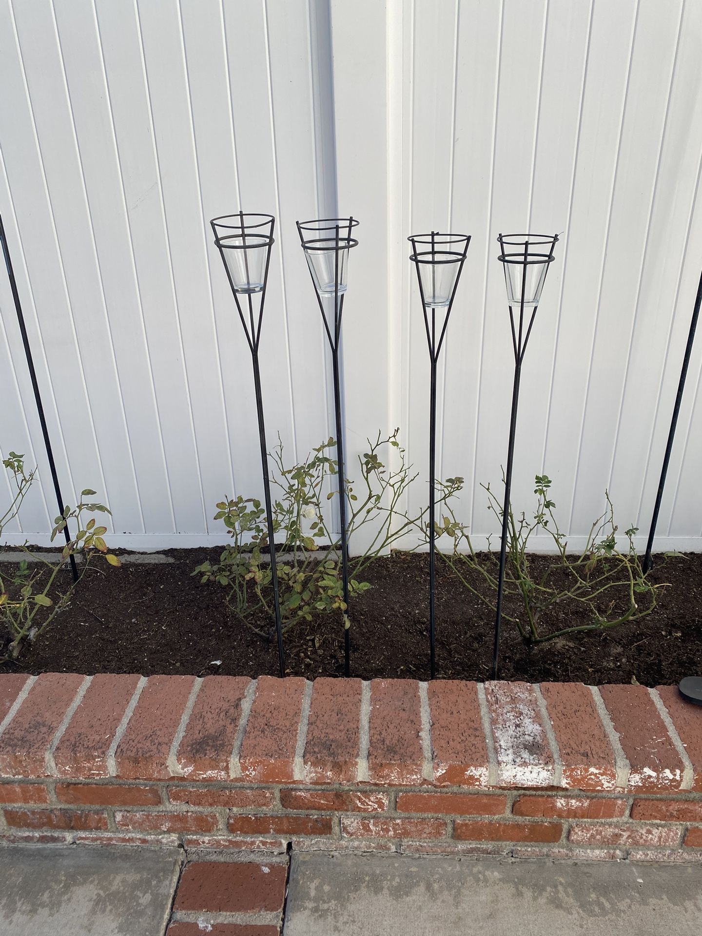 Four Black Garden Stakes with Tea Light Cups, about 48” tall