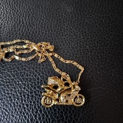 Necklace and gold motorcycle pendant