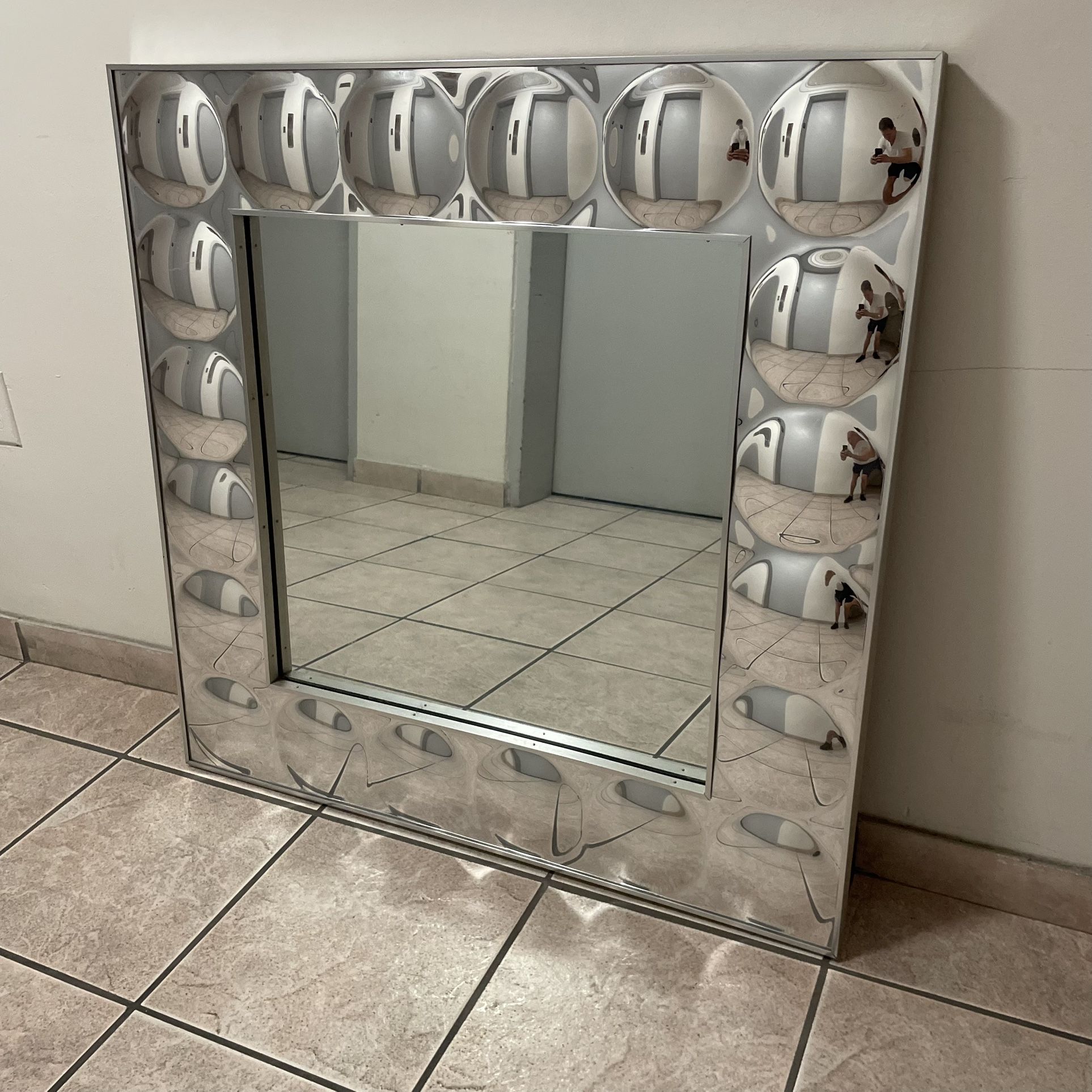 Vintage mid century modern Turner bubble mirror that measures 36” h x 36” w x 1.5” d and can be seen near the Miami Design District.