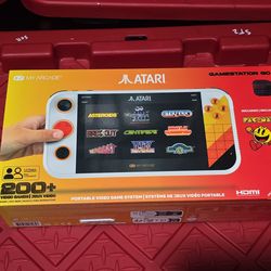 Atari Gamestation Go with memory card and games.