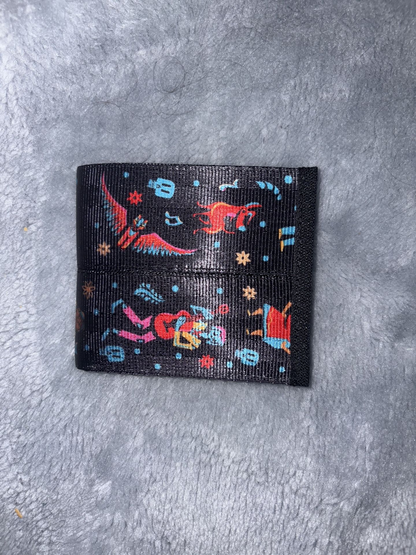 Harvey's Seatbelt Bags bifold wallet featuring artwork from Disney Pixar Coco