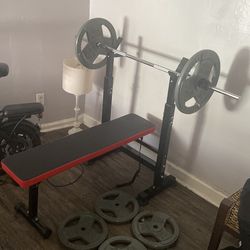 Foldable bench press with 200 pounds worth of plates  and barbell included