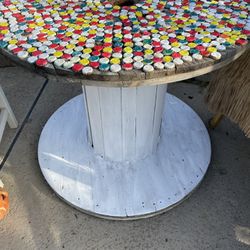 Rustic shabby outdoor spool wood table with bottle cap nailed on top- 39.5 inches wide/ 32 inches high