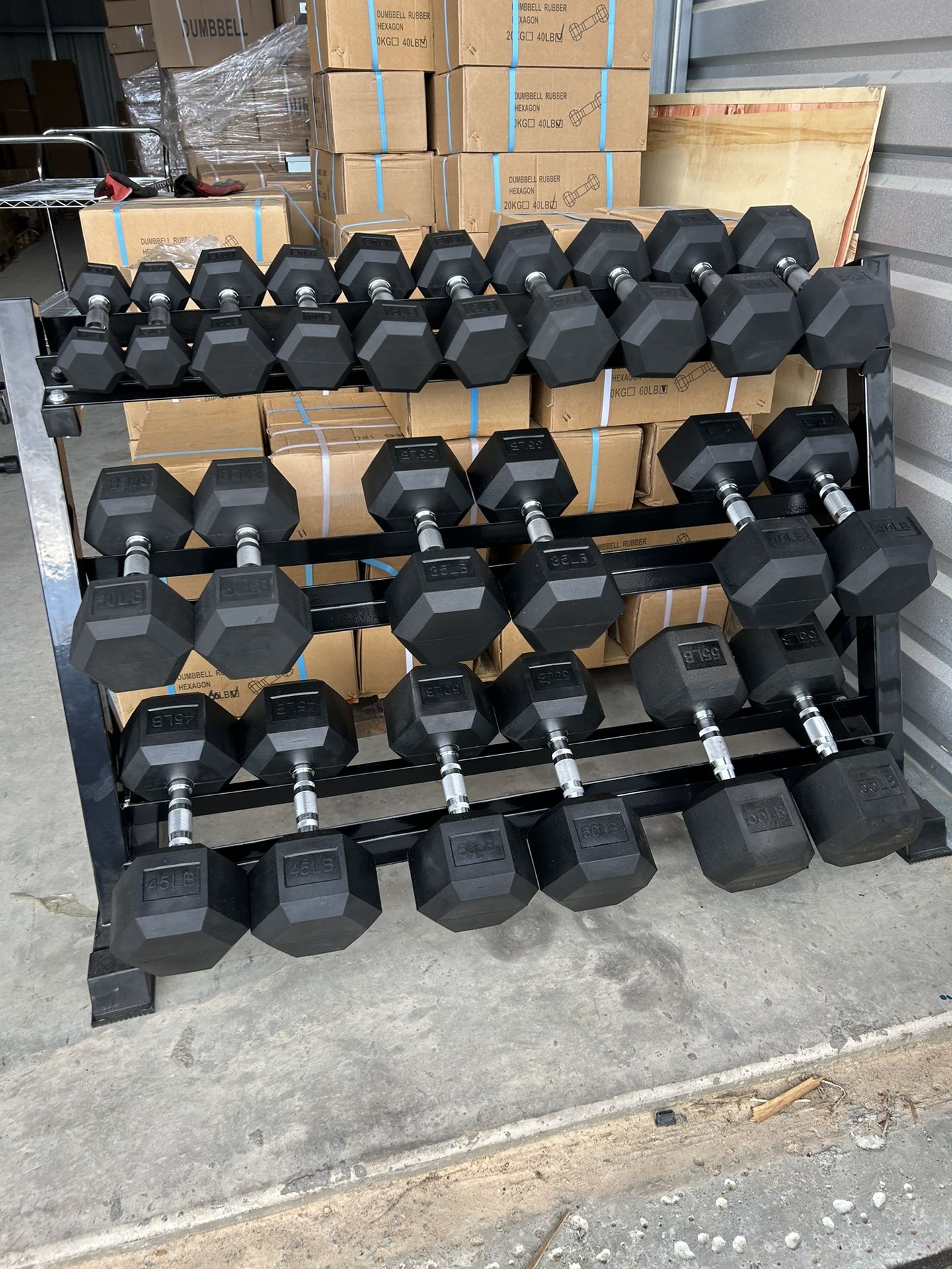 New pair of 5,10,15,20,25,30,35,40,45,50, 55 rubber dumbbells + rack. All new in box $760