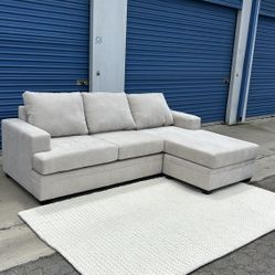 Beige Living Spaces Couch Reversible Sectional