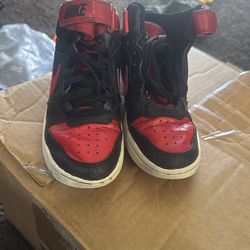 Size 5 color red and black Nikes