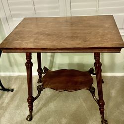 Antique solid oak parlor table with brass foo dogs and claw feet.