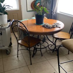 Dining room table for chairs, iron, and wood