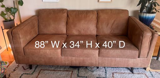Maimz faux leather sofa and 55” Samsung TV for sale