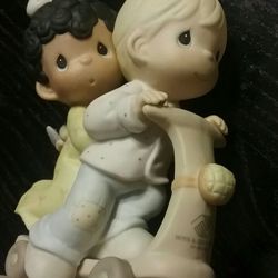Precious Moments "Love Is Color Blind" figurine.