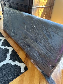 Upholstered Headboard Still in Plastic Wrap