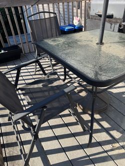 Patio table set with 4 chairs and umbrella base