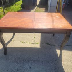 Solid wood table with insert.