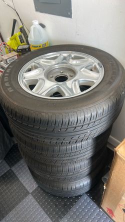 4 Tires and Rims from a Cadillac