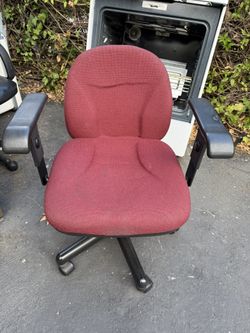 Red upholstered fabric office chair with arm rests