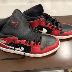 Air Jordan 1 Mids in a black/red/white colorway, men’s 9.5