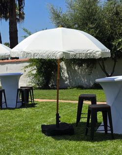 Table, chairs, fringe umbrellas, cocktail tables