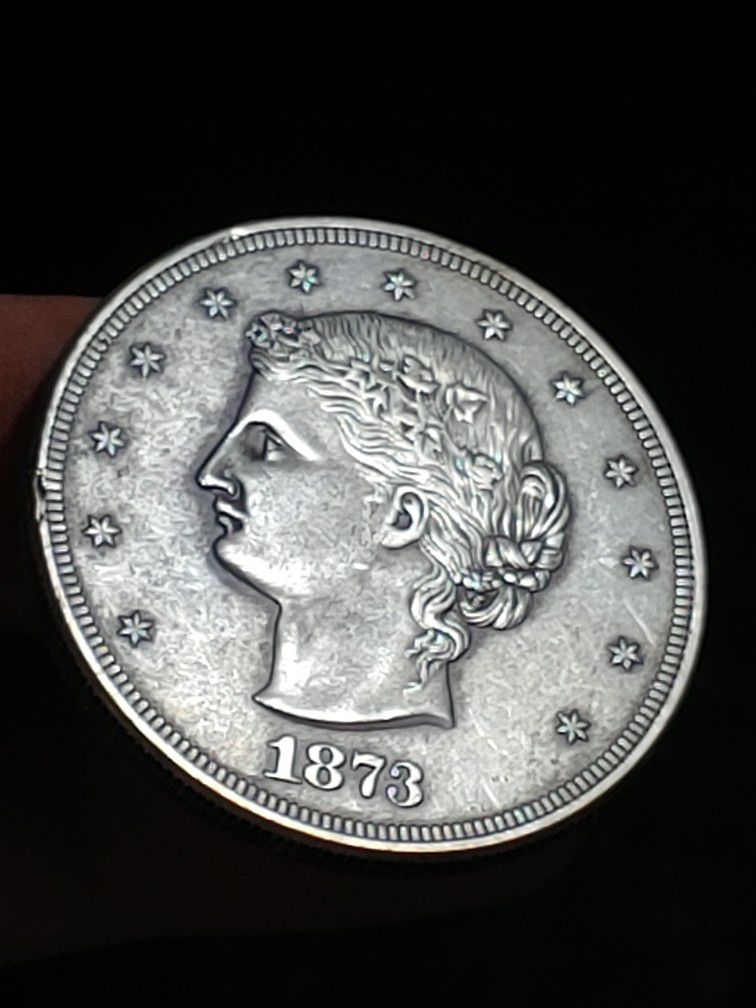 (ART-RECREATED COLLECTING COIN) 1873 TRADE DOLLAR.** LIBERTY $1 ** D: 38.0X2.4MM. W: 26.5GR.**METAL:  BRASS/SILVER PLATED.